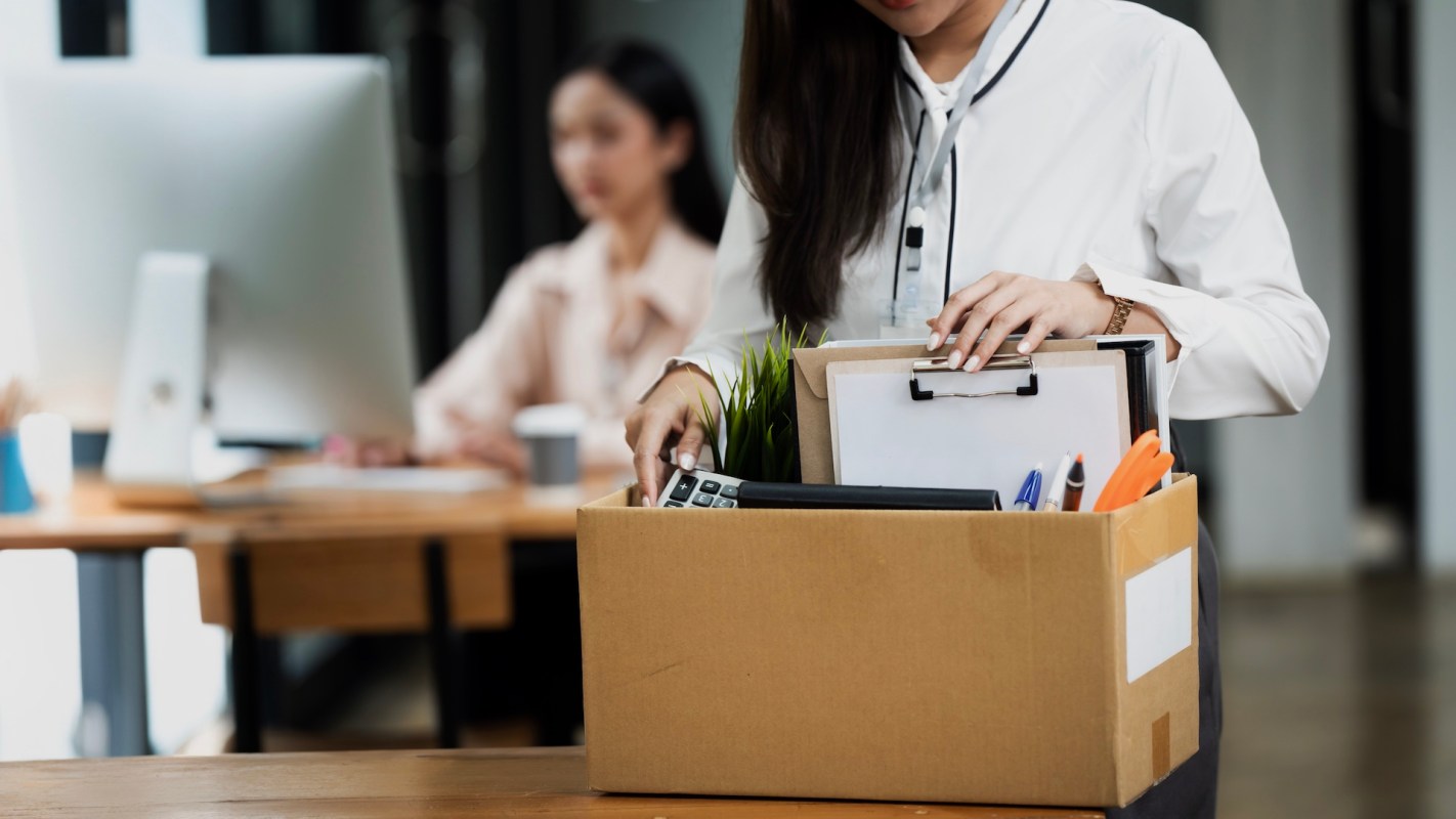 A person packing up their office.