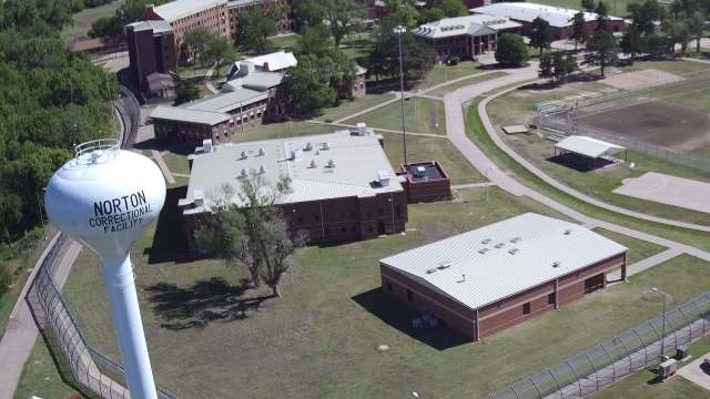 Aerial view of Norton Correctional Facility, including buildings, a water tower, and surrounding grounds.
