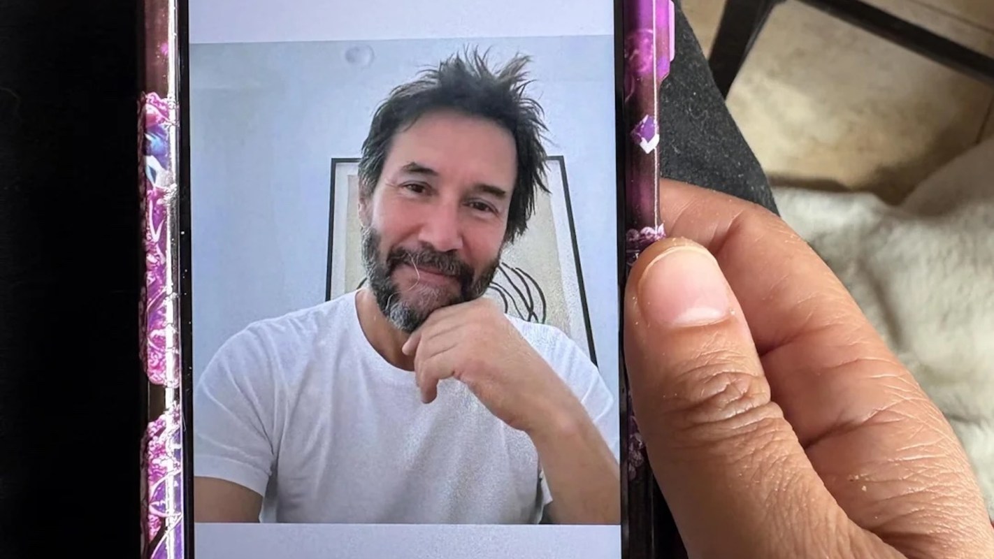 A person is shown in a video call on a smartphone screen.