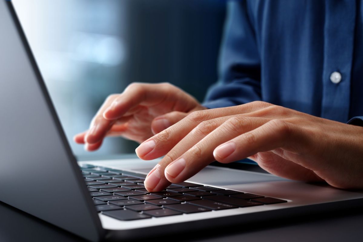 A person typing on a laptop.