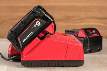 A lithium-ion battery for a power tool is plugged into a port to charge