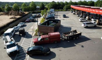 Cars lined up at a gas station.