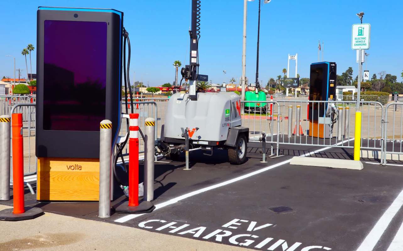 Two EV charging stations with barriers.