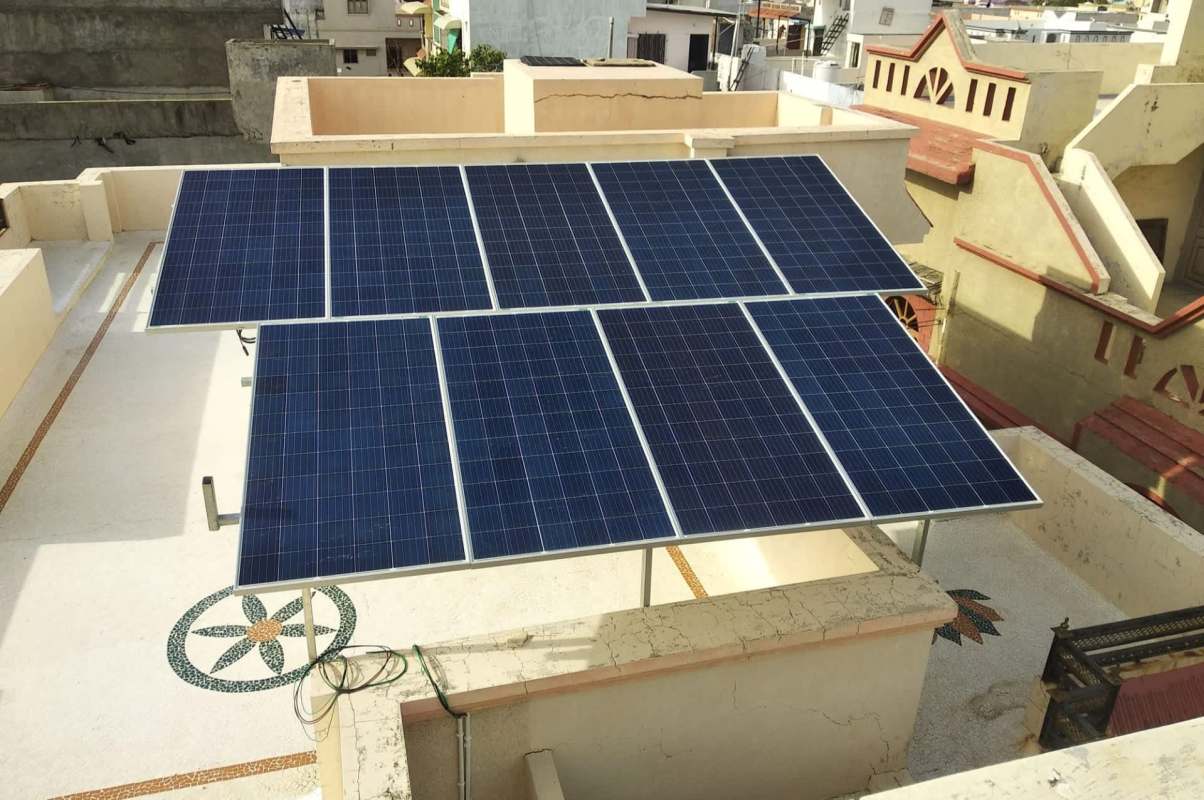 A rooftop solar panel sits atop a house in India
