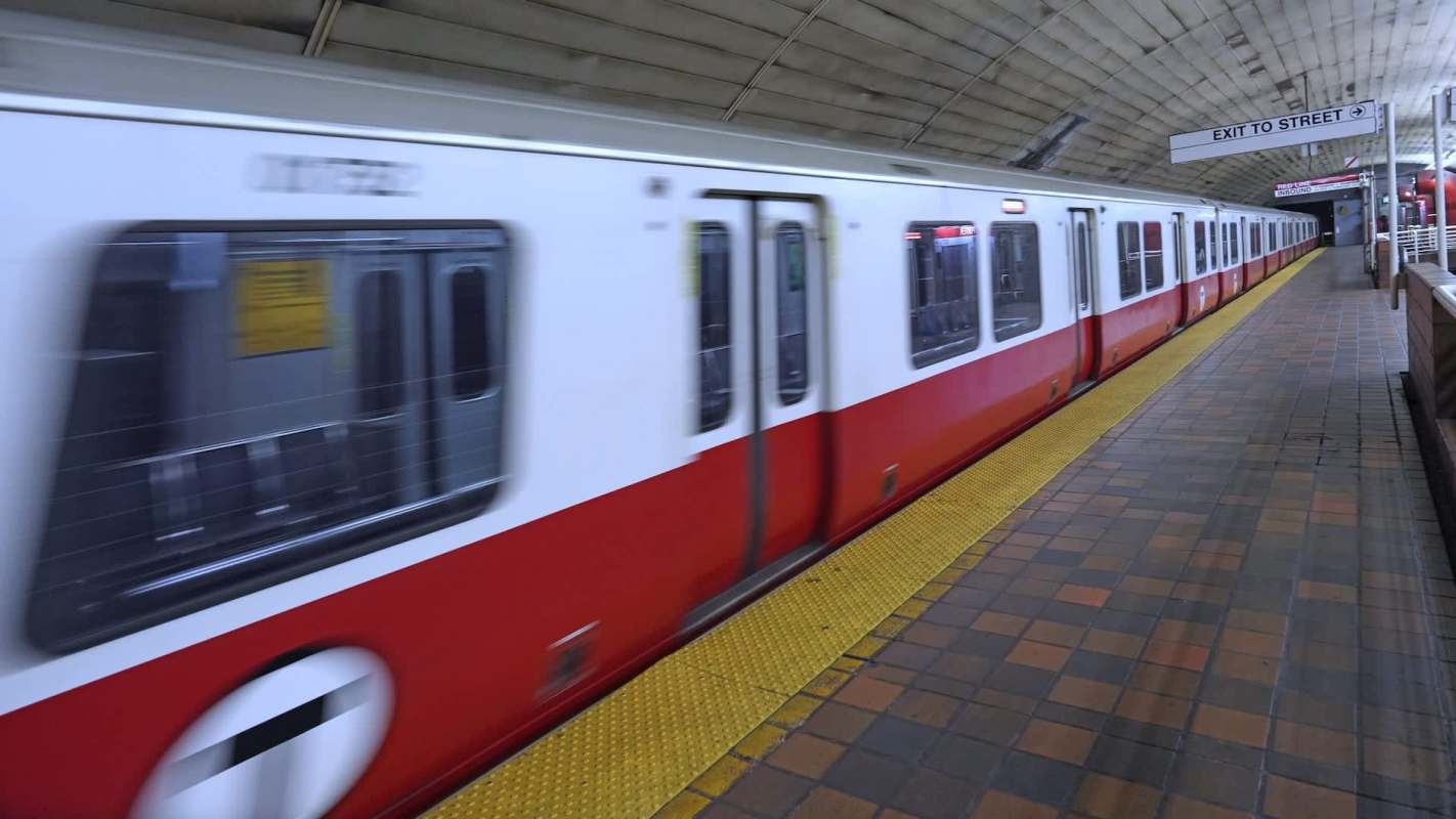 A train moves through a subway station.