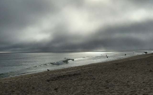 A beach on a dark, stormy day.