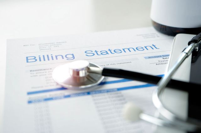 A billing statement for medical expenses with a stethoscope