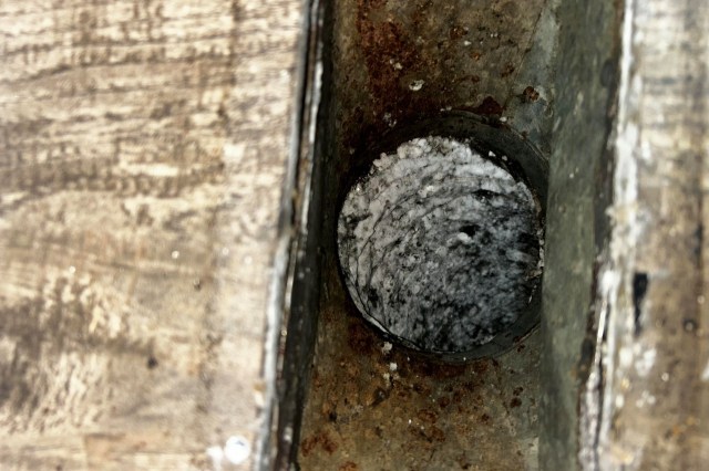A closeup image of a vent with mold