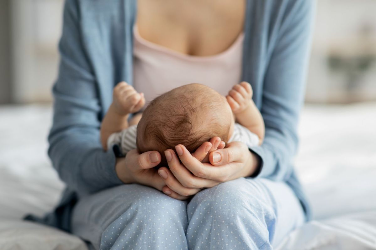 A mother holding a newborn.