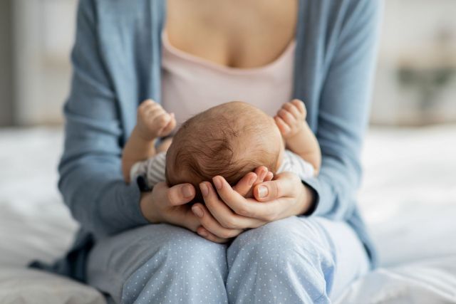 A mother holding a newborn.