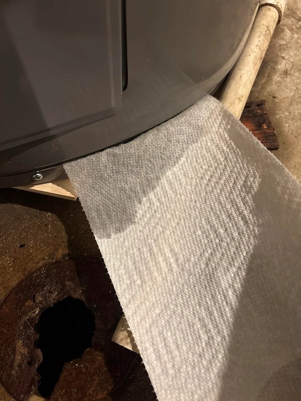 A paper towel is positioned near a metal container and a wooden surface.