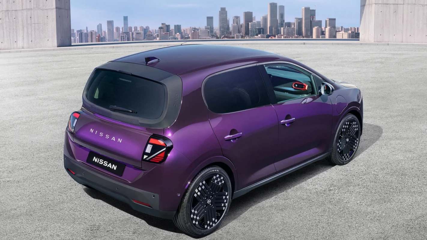 A purple Nissan car parked on a rooftop with a city skyline in the background.