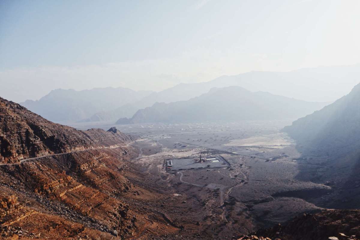 A panoramic view of a mountainous landscape with rocky terrain and a valley below.