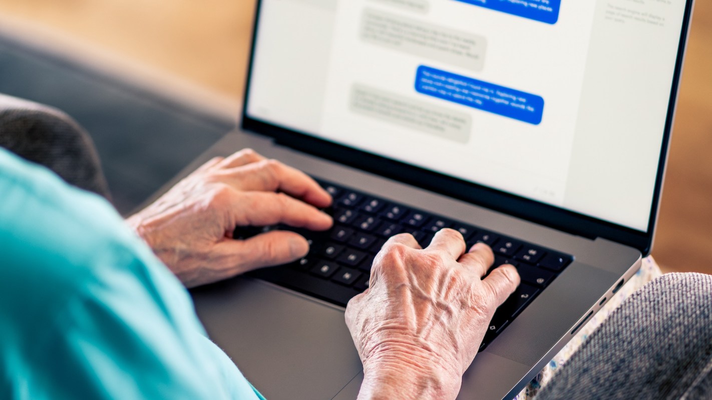 A person using a messaging interface on a laptop computer.