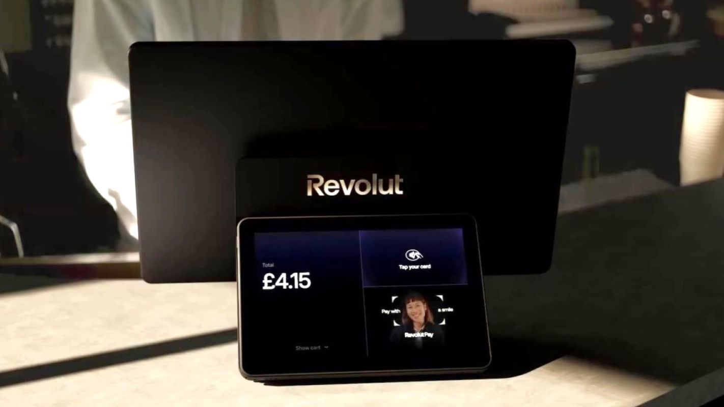 A digital payment terminal displaying scanned face, a total amount of £4.15 and instructions for payment.