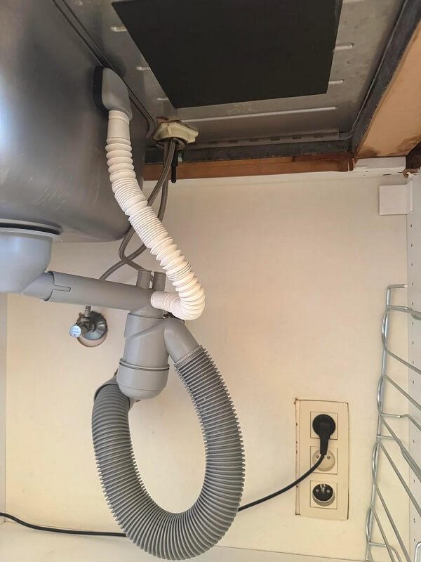 Pipes under a kitchen sink.