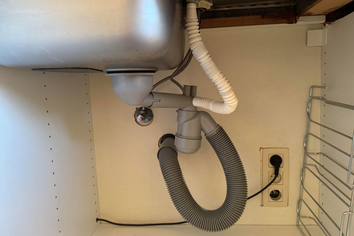 Pipes under a kitchen sink.