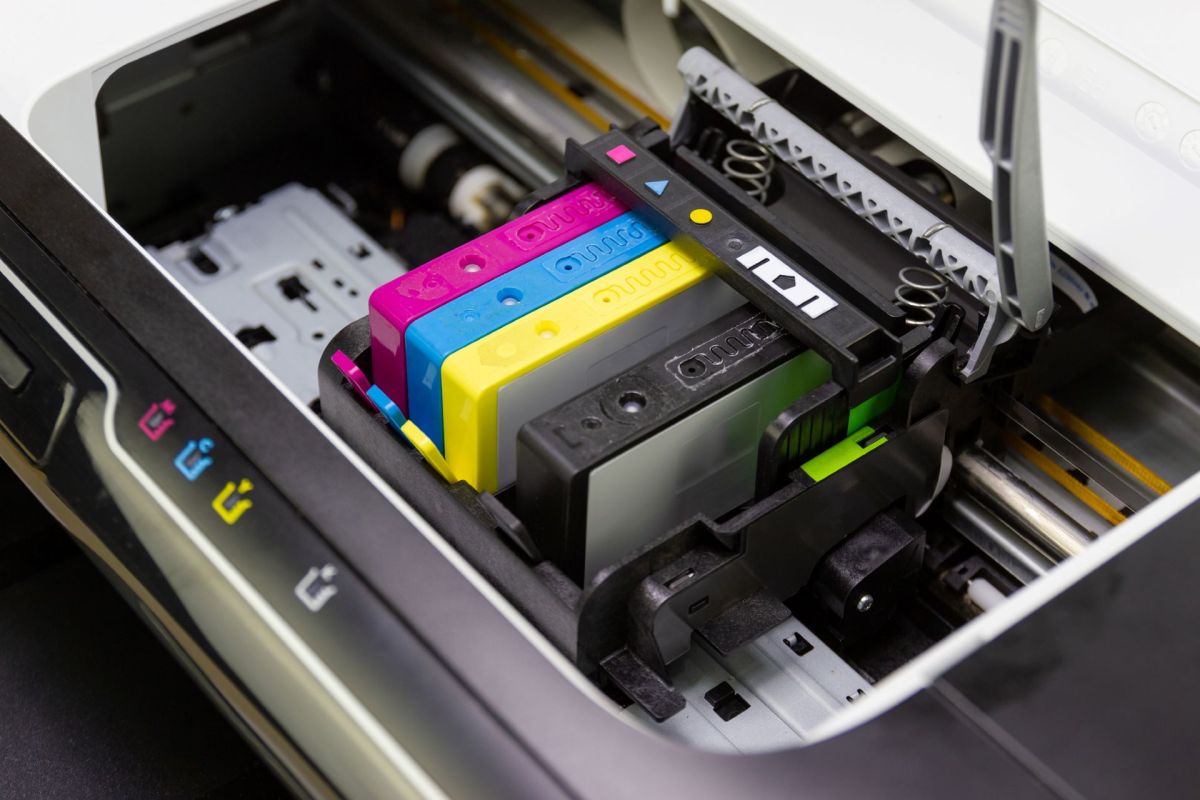 An inkjet printer with color ink cartridges installed in the print head.