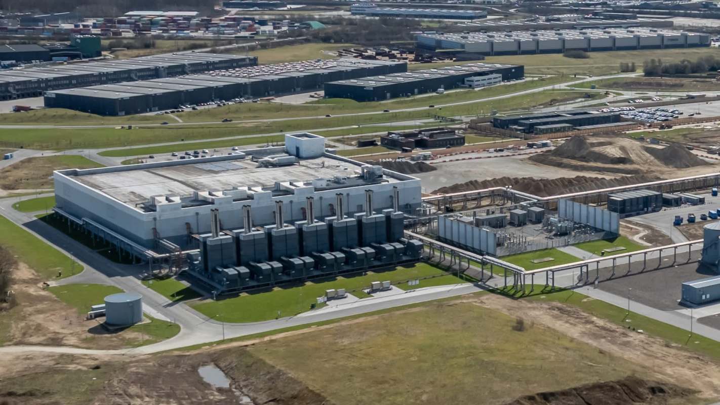 An industrial facility with machinery and storage containers in an outdoor setting.
