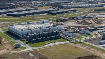 An industrial facility with machinery and storage containers in an outdoor setting.