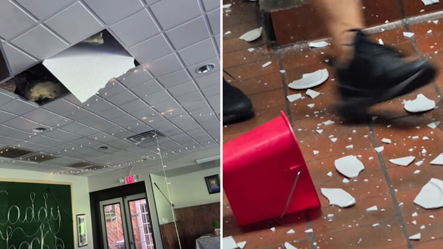 Damage to a ceiling with a large hole and debris scattered on the floor, including broken plates and a red bucket.