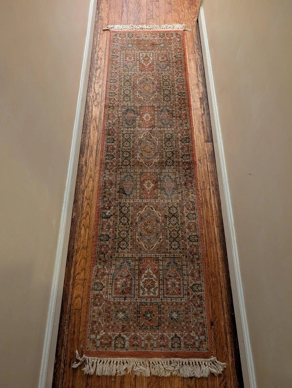 colorful rug laid out on a wooden floor