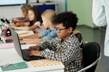 School students working on laptops.
