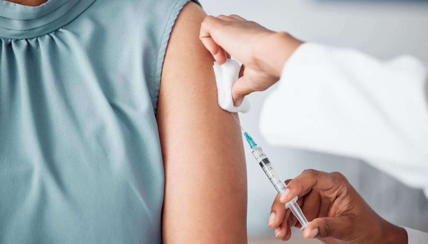 A person receives a vaccination in a healthcare setting.