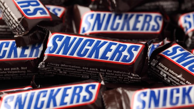 Several Snickers chocolate bars arranged close together.