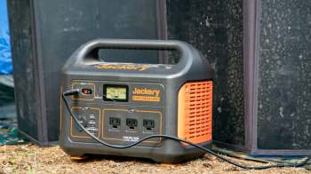 A portable power station with display and multiple output ports.