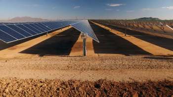 Rows of solar panels in a field.