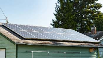 Solar panels installed on the roof of a green house.