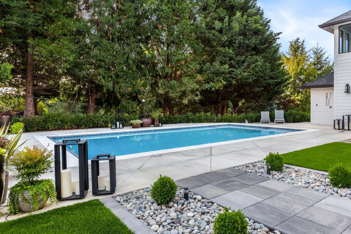An in-ground pool in a backyard.