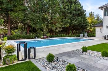 An in-ground pool in a backyard.