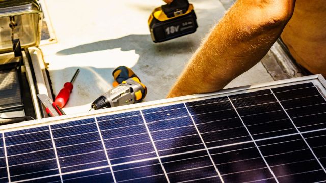 A person working on a solar panel.