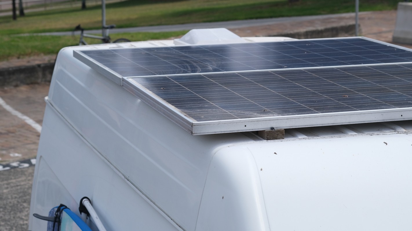 A solar panel installed on the roof of a white vehicle.