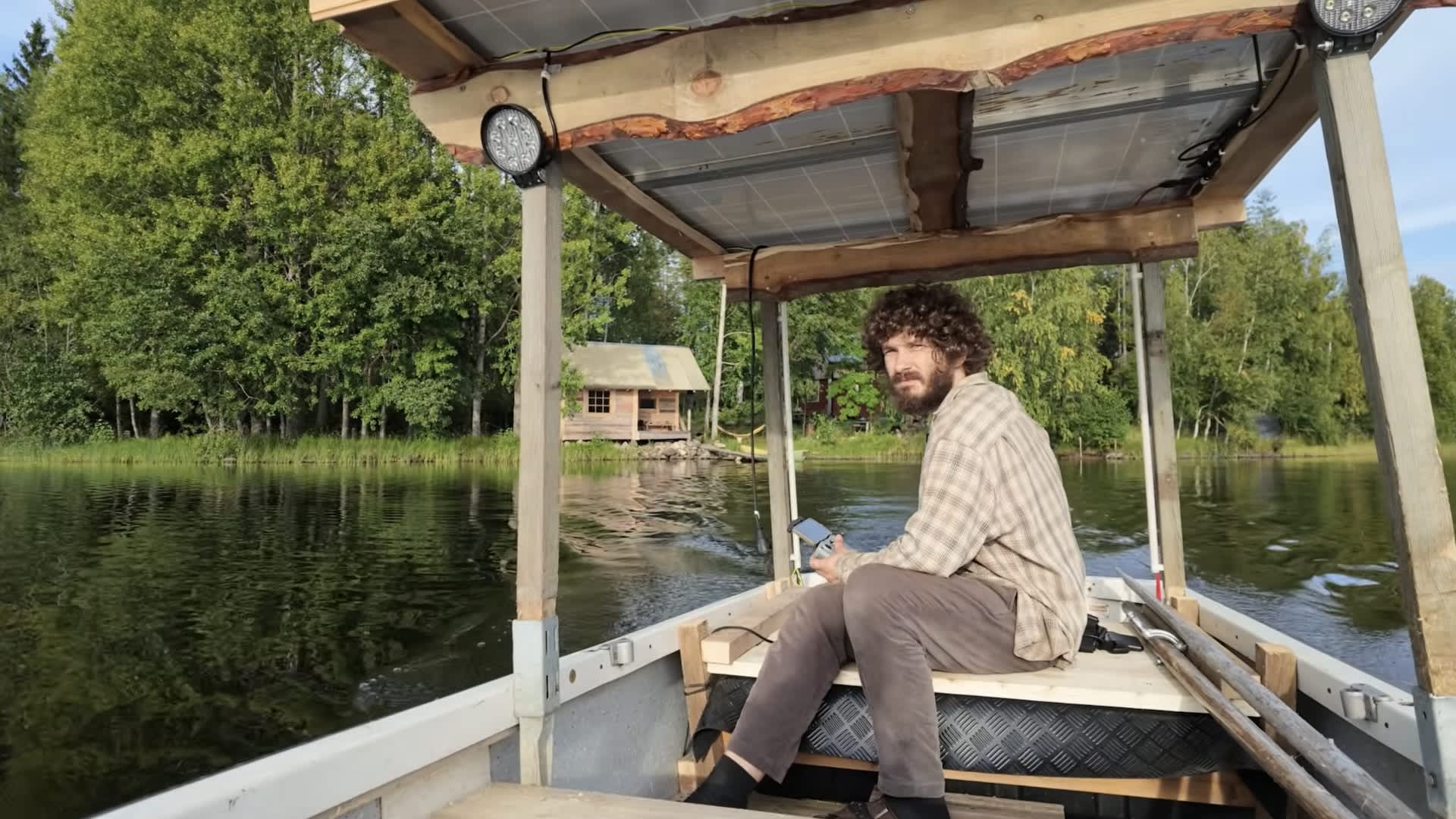 Island homesteader builds solar-powered boat that hauls gear, crosses lake, and backs up house