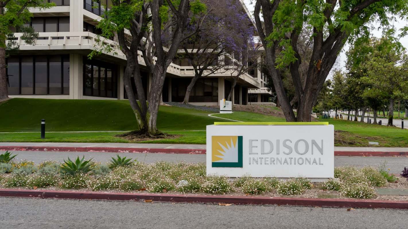 A sign for Edison International in front of a modern building and landscaped area.