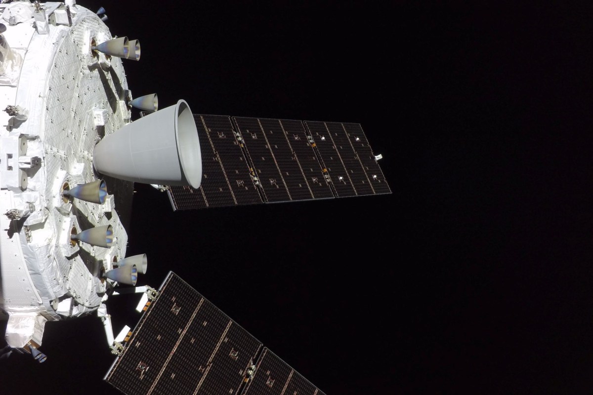 Two panels of solar cells extend from a spacecraft in space