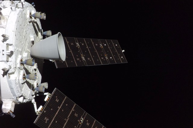 Two panels of solar cells extend from a spacecraft in space