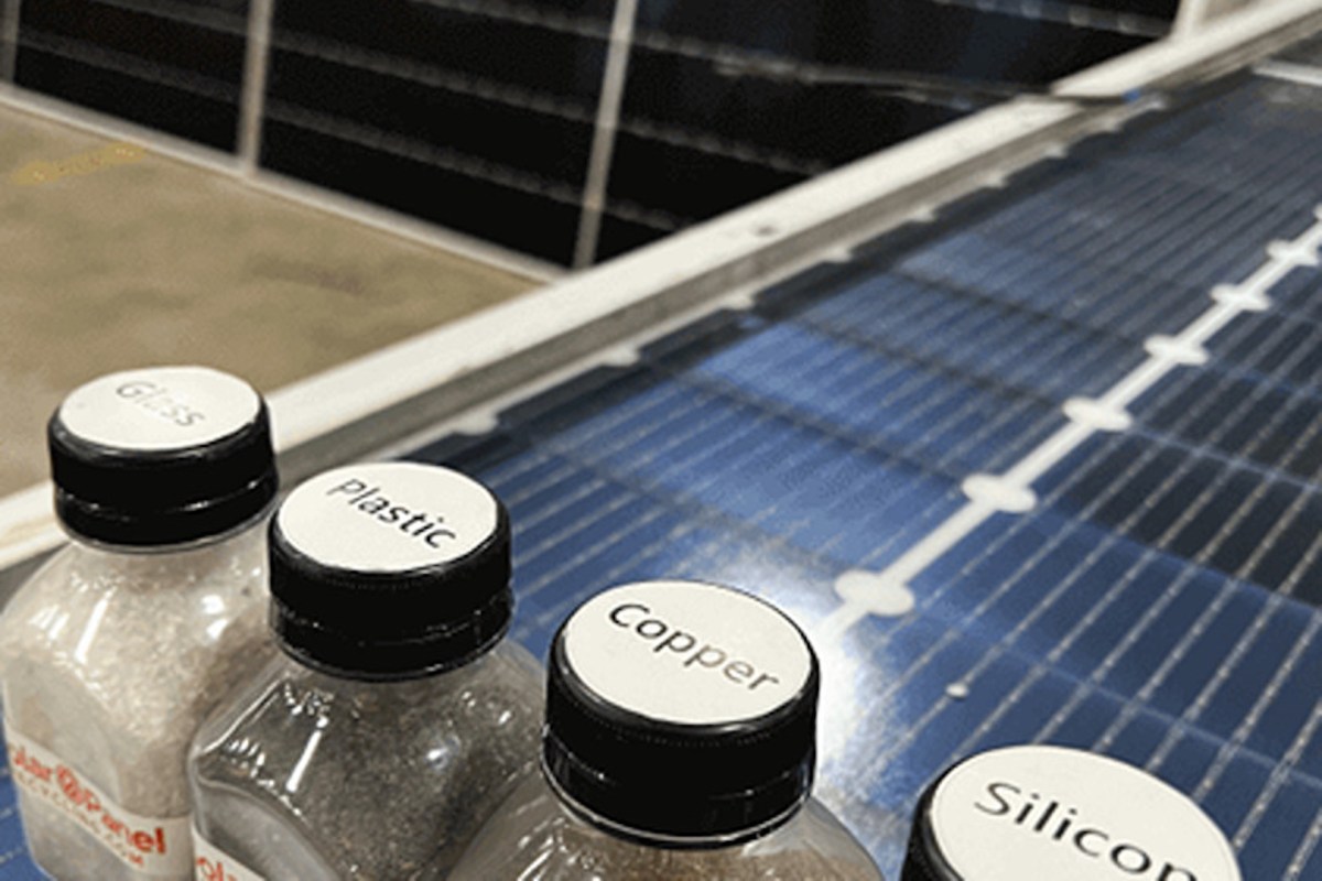 Solar panels behind bottles of solar panel materials.