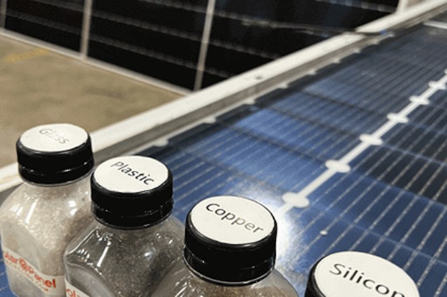 Solar panels behind bottles of solar panel materials.