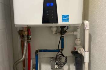 A water heater with visible pipes and a digital temperature display.
