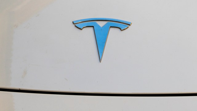 A Tesla logo on a white surface.