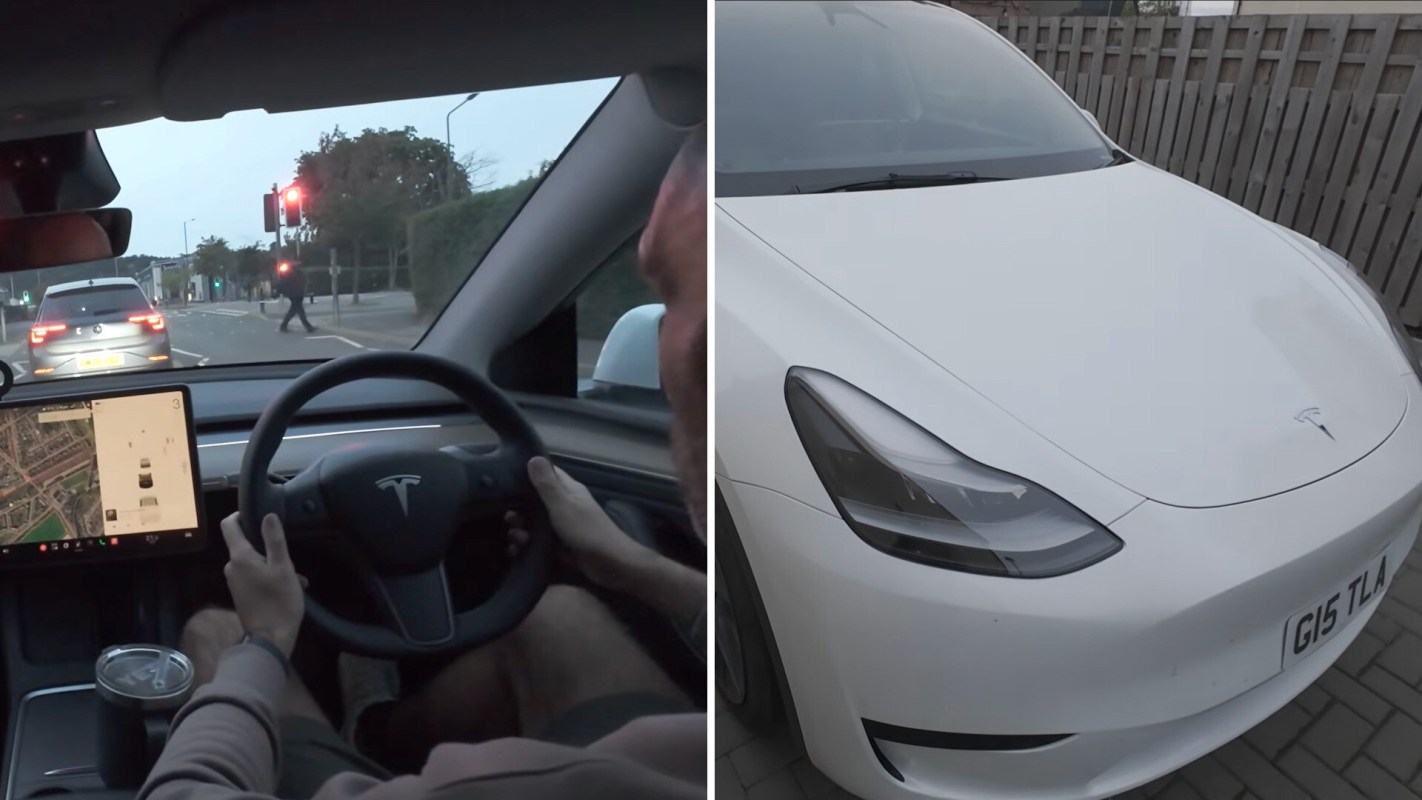 A person driving a Tesla with a digital map display, stopped at a traffic light.