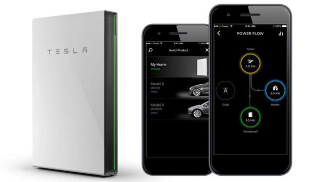 A Tesla Powerwall and two smartphones displaying energy management apps.