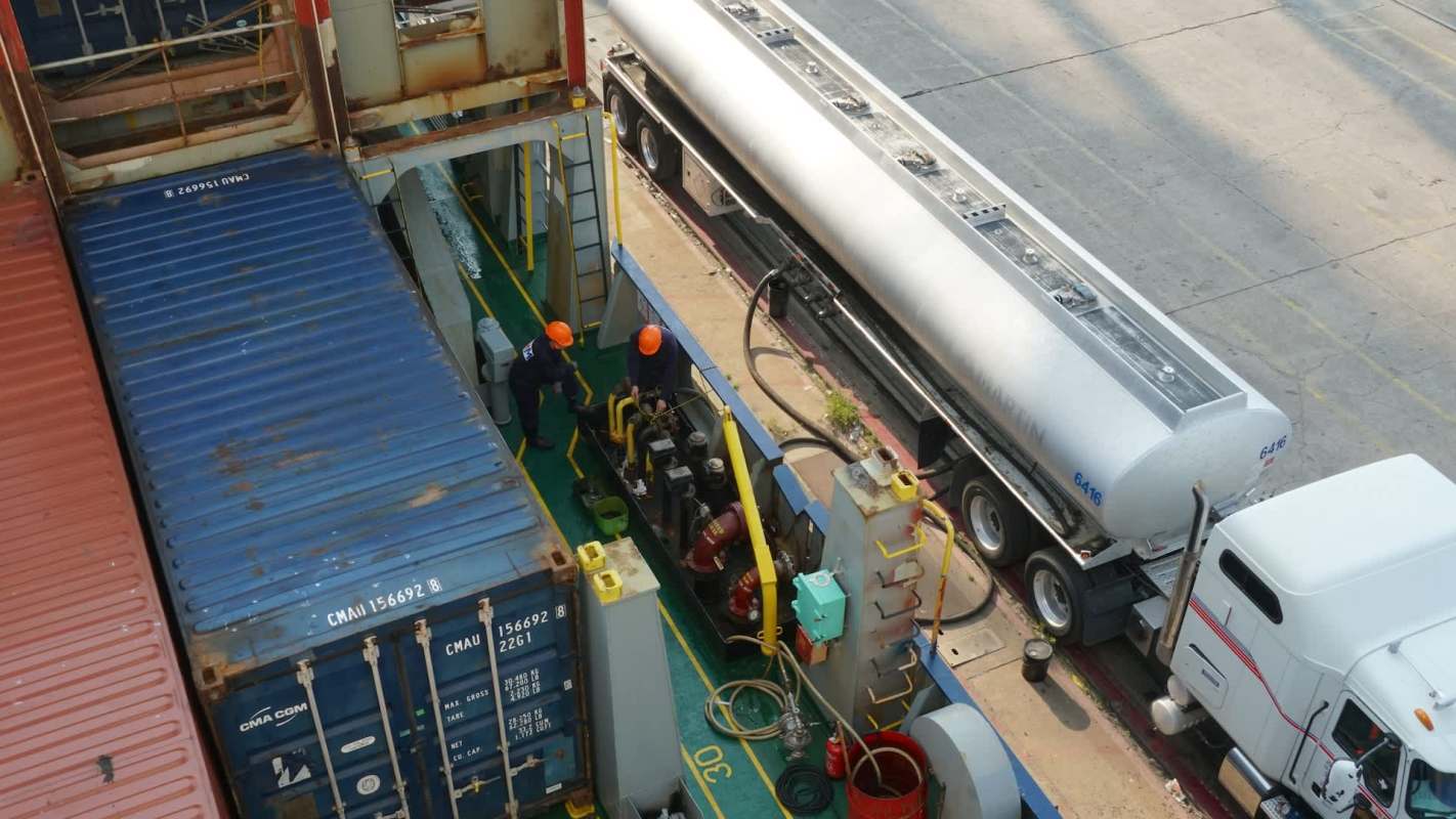Two workers on a cargo ship.