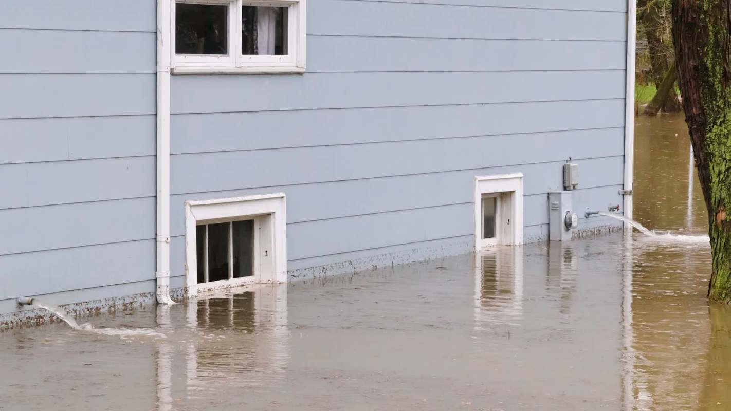 A house partially submerged in floodwater.