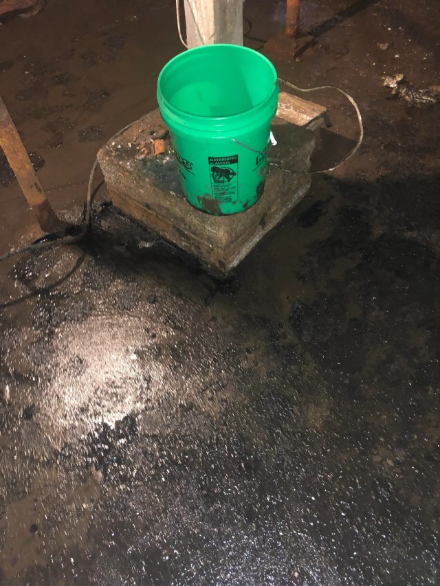 Black sludge and a large green bucket.