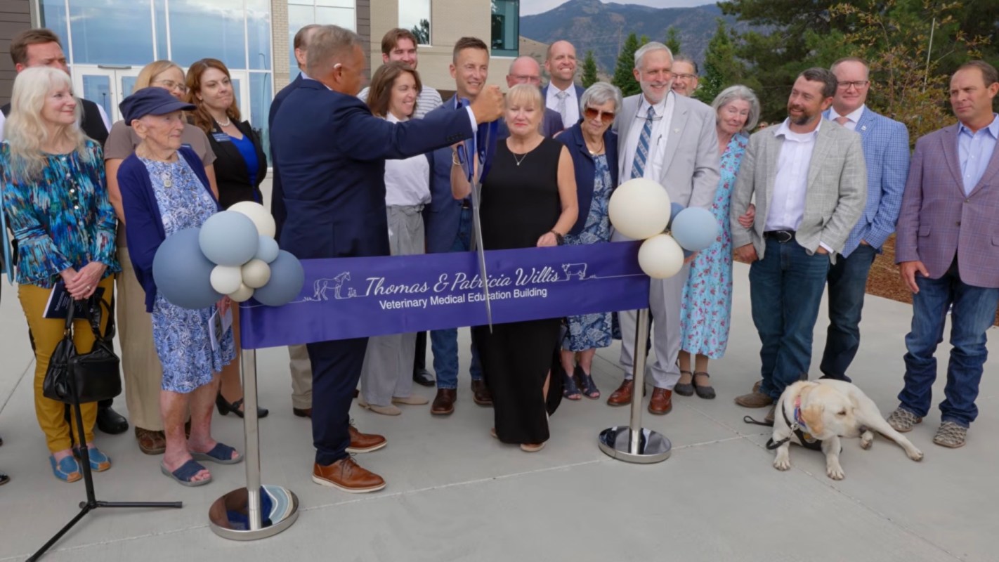 A group of people gathers to celebrate the opening of the Thomas & Patricia Willis Veterinary Medical Education Building.